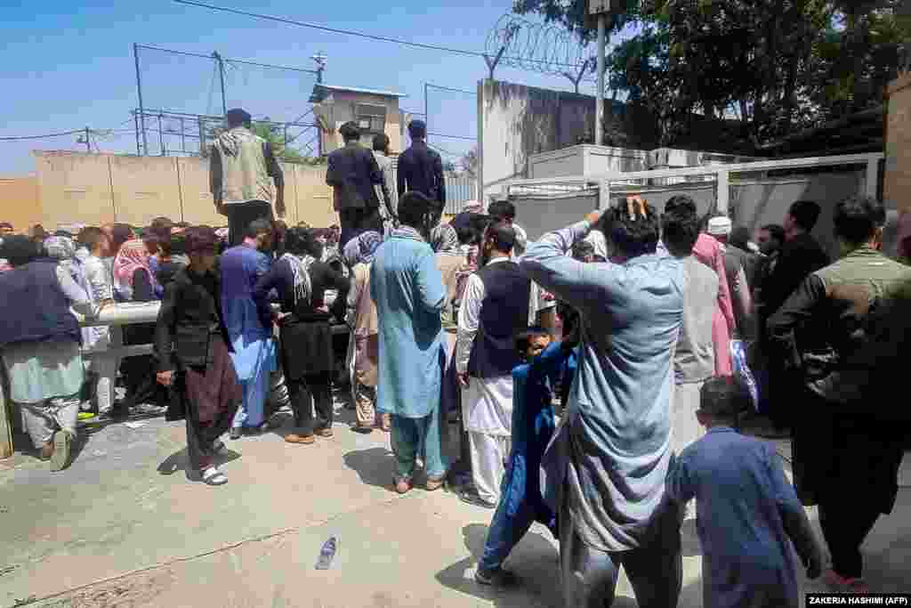 Afghans line up outside the French Embassy in Kabul on August 17 seeking visas and permission to get on a military flight to leave Afghanistan.