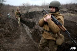 Ukrainian soldiers patrol along a position at the front line with Russia-backed separatists not far from Avdiyivka in the Donetsk region on April 5.