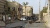 Debris litters the street outside the Syrian Catholic Church the morning after the deadly October 2010 attack.