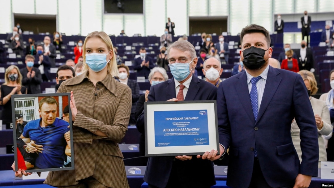 Leonid Volkov (right) poses with Aleksei Navalny's daughter Daria Navalnaya (left) and European Parliament President David Sassoli during the award ceremony for the Sakharov Prize at the European Parliament in Strasbourg, France, on December 15, 2021.