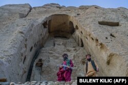 Taliban fighters guard the former site of the Bamiyan Buddhas.