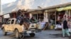 Taliban soldiers fighters ride through town in a pickup truck in Panjshir in December 2021.