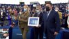 Darya Navalnaya (left) accepted the award in Strasbourg on December 15 while holding a portrait of her imprisoned father.