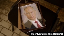 A portrait of Russian President Vladimir Putin is seen at a preliminary detention center in Kherson that Ukrainians say was used by Russian soldiers to jail and torture people before they retreated.