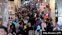 Iranians shop at the Grand Bazaar in Iran's capital, Tehran.