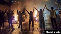 Iranian youths protest in the western city of Sanandaj on November 16.