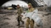 Ukrainian sappers carry a Russian military drone at the Antonov airport in Hostomel on the outskirts of Kyiv on April 18.