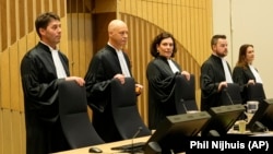 Presiding Judge Hendrik Steenhuis (second from left) stands before the verdict session of the Malaysia Airlines Flight 17 trial at the high-security court at Schiphol Airport, near Amsterdam, on November 17.
