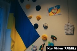 A Ukrainian flag and hand-made drawings on the wall of the children's center.