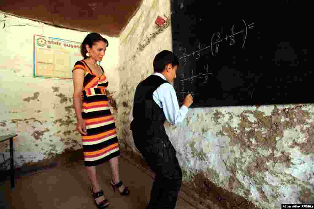 A teacher monitors math class in a Jalilabad school. 