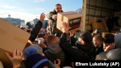 People receive humanitarian aid in the Ukrainian city of Kherson on November 15.