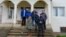 Ethnic Serbs hold a picket on the steps of an office for Serb self-government in the southern Kosovar village of Verboc earlier this month. 