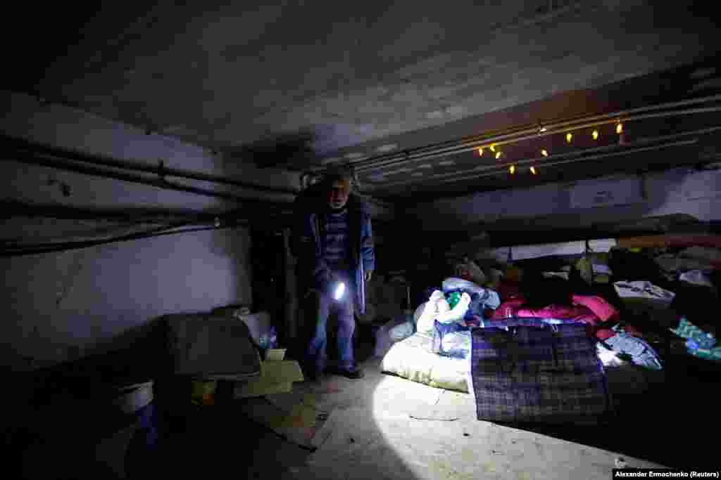 Pavlo shows off the cold, dark basement where he and Halyna have lived since their home was destroyed in March. &nbsp;