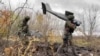 Russian soldiers carry an Orlan-10 drone in eastern Ukraine.