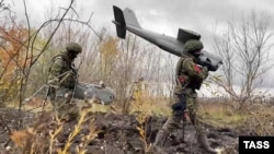 Russian soldiers carry an Orlan-10 drone in eastern Ukraine.