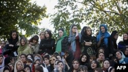 Iranian women, segregated from men, watch a street-style football skills contest in Tehran. File photo