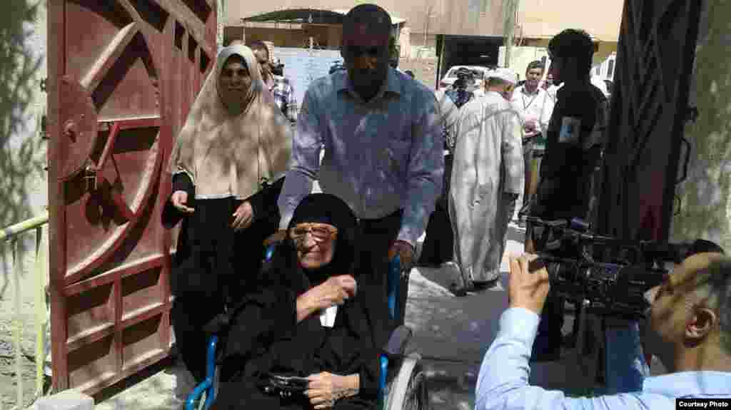 A group of voters arrives to cast their ballots in Basra.