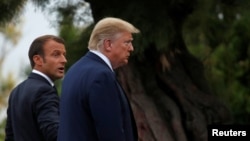 French President Emmanuel Macron (left) welcomes U.S. President Donald Trump to the G7 summit in Biarritz on August 24. 