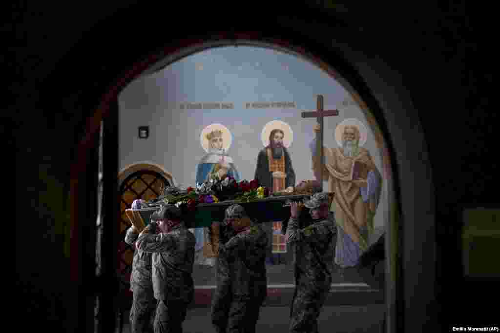 Soldiers carry the body of Viacheslav Nalyvaiko, a Ukrainian military officer killed during fighting against Russians, during his funeral in Kyiv.