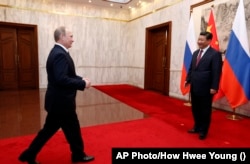 Russian President Vladimir Putin meets with Chinese leader Xi Jinping in Beijing in 2014.