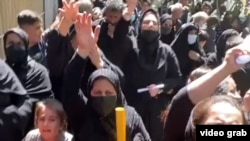 A screen grab of a video shared on social media showing protesters in front of Iran's judiciary on September 11.