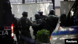 Members of a police special unit enter the Iranian Embassy in Tirana after Albania cut ties with Iran and ordered diplomats to leave over a cyberattack it blamed on Tehran on September 8.