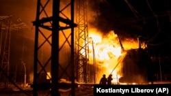 Ukrainian emergency workers put out a fire after a Russian rocket attack on an electric power station in Kharkiv on September 11. 