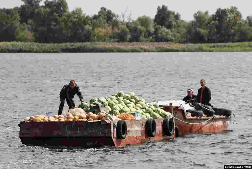 Fruit sellers transport melons, grapes, peppers, and other produce across the Dnieper on September 8. This photo and others taken by a photographer from the Kremlin-funded TASS news agency show the impact that strategic strikes by Ukrainian forces are having on everyday life in Kherson. &nbsp;