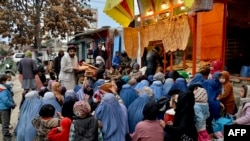 آرشیف - زنان و کودکان بی بضاعت در مقابل یک خبازی در کابل نشسته اند تا افراد متمول به آنها نان خشک رایگان توزیع کنند.