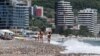 People enjoy the sun on a beach in Budva, the main summer tourist destination Montenegro May 24, 2022. Picture taken May 24, 2022. REUTERS/Stevo Vasiljevic