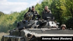 Ukrainian soldiers on a BTR amphibious armored personnel carrier drive out of Bakhmut in the eastern Donetsk region on September 7.