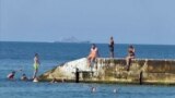 Turists swimming and sitting by the sea in Crimea