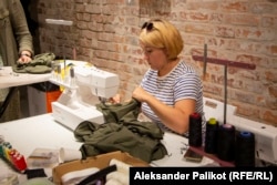 A volunteer sews military clothing at the Dnipro Center for Contemporary Culture.