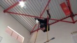 Deir Al-Assad, Israel -- Female trapeze artist with a hijab doing acrobatics