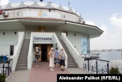 Volunteers have been giving free meals to people displaced by the war at Poplavok, a restaurant in an iconic circular concrete building rising from the surface of the Dnieper River.