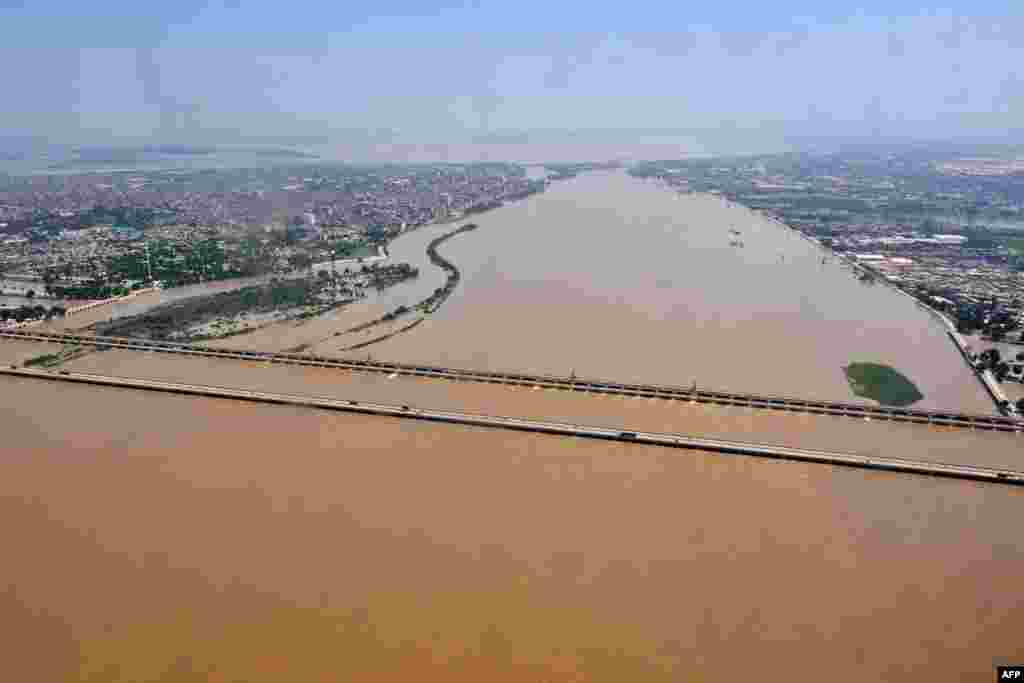 The flooded Indus river along the Sukkur Barrage in Sukkur, Sindh Province, on August 31. Pakistan Prime Minister Shehbaz Sharif said on September 7 that parts of the country seemed &quot;like a sea&quot; after visiting some of the flood-hit areas, where the death toll climbed above 1,300. &quot;You wouldn&#39;t believe the scale of destruction there,&quot; Sharif told reporters. &quot;It is water everywhere as far as you could see. It is just like a sea.&quot;