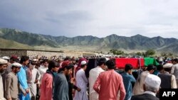 Mourners carry the coffin of an Afghan security member of a border post killed by Taliban fighters, during a funeral in Dande Patan district of Paktia Province on May 29.