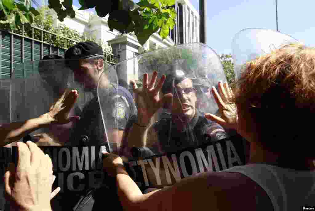 Escorts of people with disabilities try to break through a police blockade outside the Greek parliament during a rally against new austerity measures in Athens on September 27. (REUTERS/John Kolesidis)