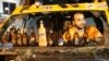 A fan relaxes in a burned-out minibus. Beer is a hot commodity in the square, where many protesters are angry that Turkish Prime Minister Recep Tayyip Erdogan has tried to restrict alcohol sales. A popular chant involves a satirical toast to the prime minister.