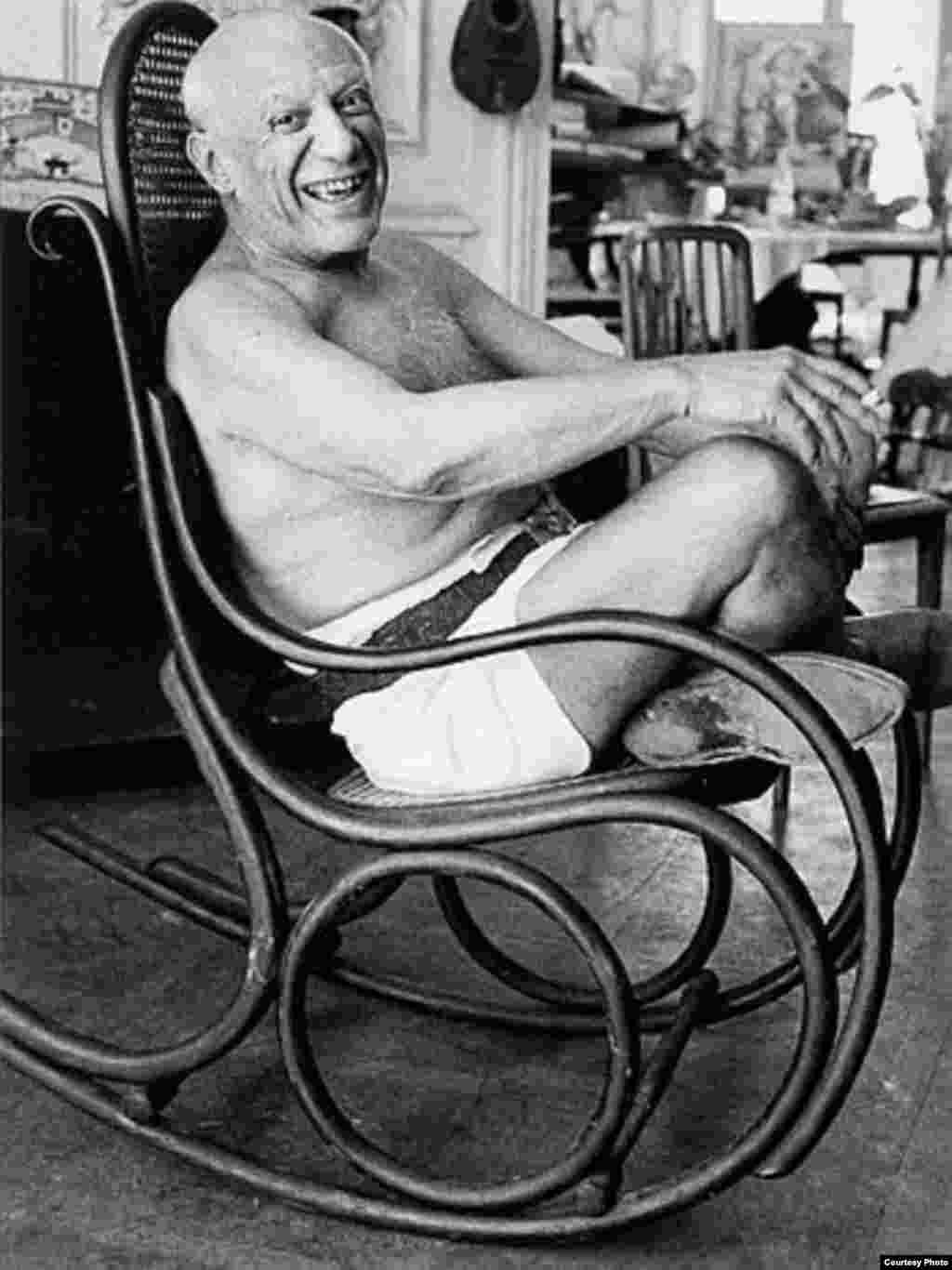 © David Douglas Duncan. Picasso laughing in his favorite rocking chair, 1957