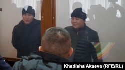 Murager Alimuly (right) and Kaster Musahanuly are seen in the defendants' cage at their trial on January 6 in Zaysan.