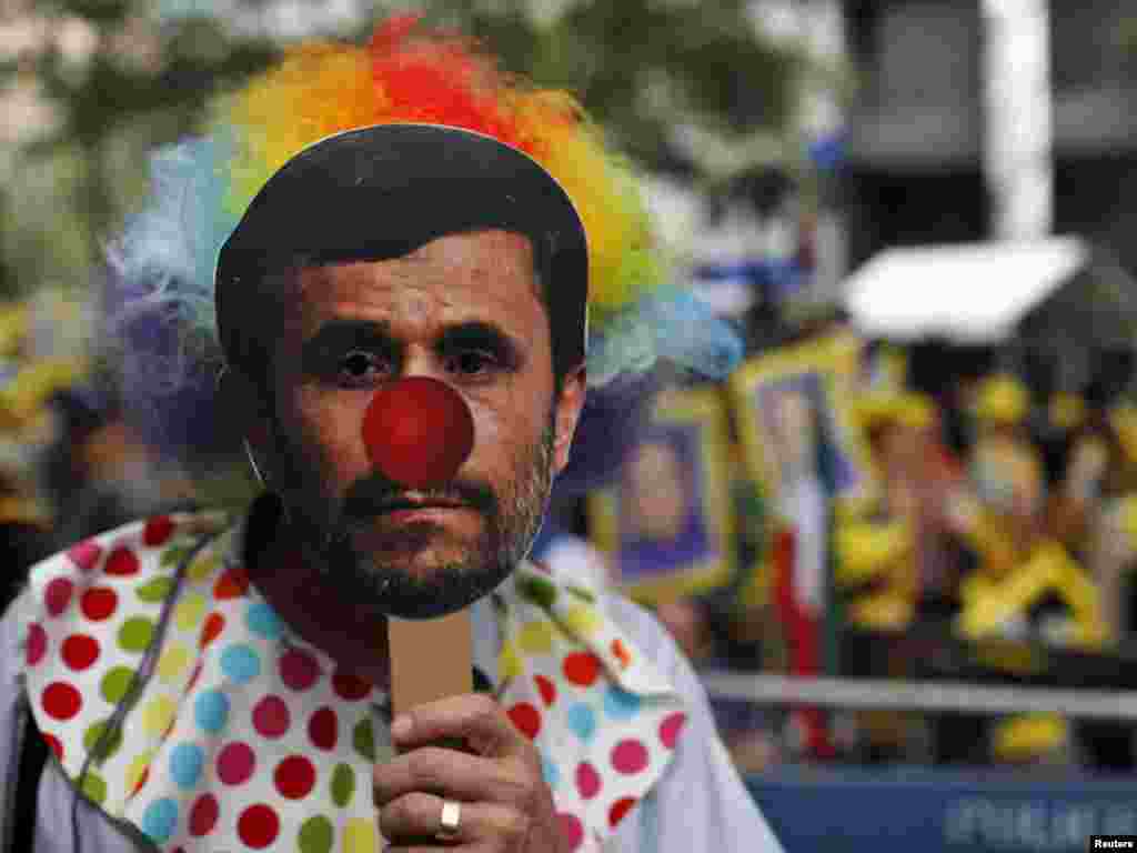 A demonstrator wears a mask depicting Iranian President Mahmud Ahmadinejad during a protest outside UN headquarters in New York on September 22. (Photo taken by Eduardo Munoz for Reuters)
