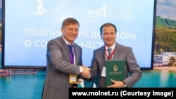 Aleksandr Dzheus (left) poses with Aleksandr Shkolnik, a member of Russia's Public Chamber, who is a frequent guest at the camp.