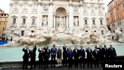 G20 leaders toss a coin into Rome's iconic Trevi Fountain on the sidelines of the G20 summit in Rome on October 31. 