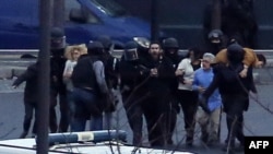 Members of the French police special forces launch the assault and evacuate the hostages at a kosher grocery store in Porte de Vincennes, eastern Paris, on January 9.