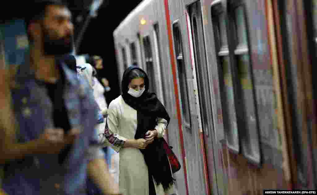 An Iranian woman takes a train in a subway station in Tehran. (epa-EFE/Abedin Taherkenareh)