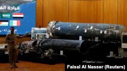 A Saudi-led coalition spokesman, Colonel Turki al-Malki, displays missiles he said were manufactured by Iran during a news conference in Riyadh this week.