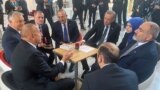 Turkish President Recep Tayyip Erdogan (center-right), accompanied by Foreign Minister Mevlut Cavusoglu, chats with Azerbaijani President Ilham Aliyev (front left), Armenian Prime Minister Nikol Pashinian (front right), and Hungarian Prime Minister Viktor Orban (back right) at the European Political Community in Prague on October 6.