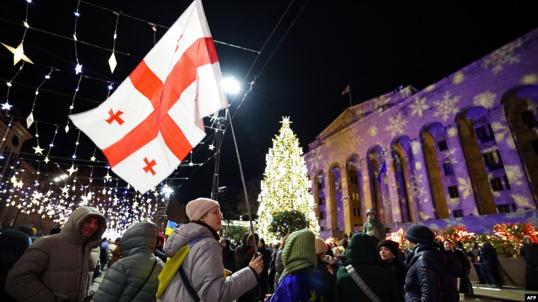 Manifestanți anti-guvernamentali, în fața clădirii parlamentului din Tbilisi. 17 decembrie 2024. 