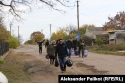 Residents of Kachkarivka greet the people evacuating them to Kryviy Rih, in Ukrainian-controlled territory.